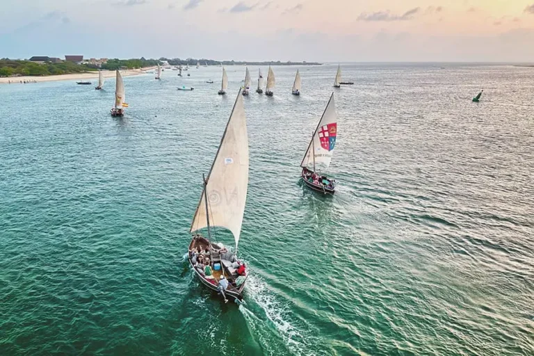 Guests enjoying dhow sundowners near Peponi Hotel on Lamu Island, Kenya.