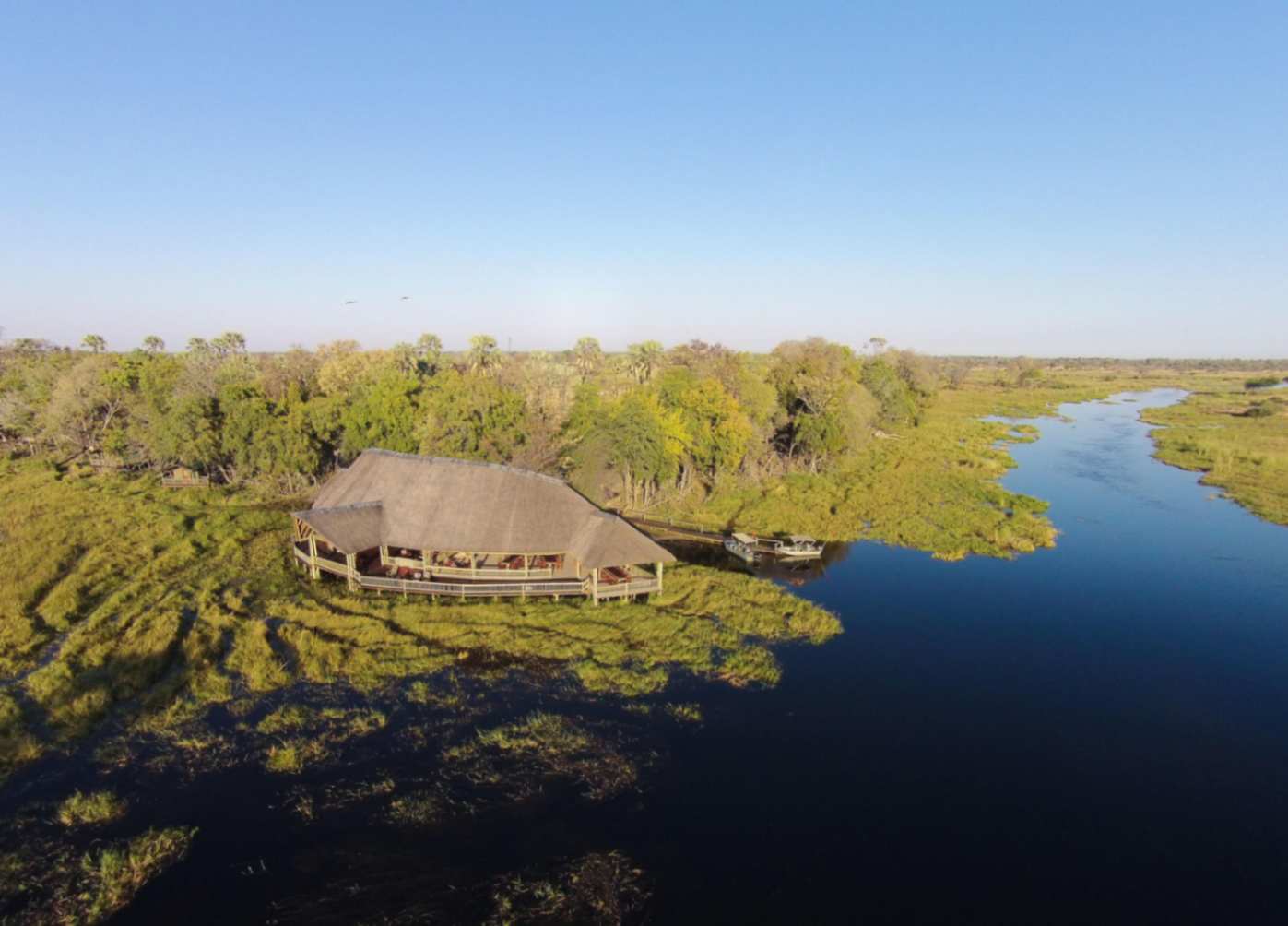 Luxury eco camp accommodation at Moremi Crossing overlooking the Okavango Delta floodplains.