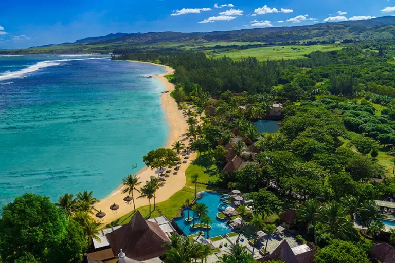 Aerial photo of Shanti Maurice Resort & Spa in Mauritius, featuring the beach, turquoise lagoon, and lush tropical gardens.