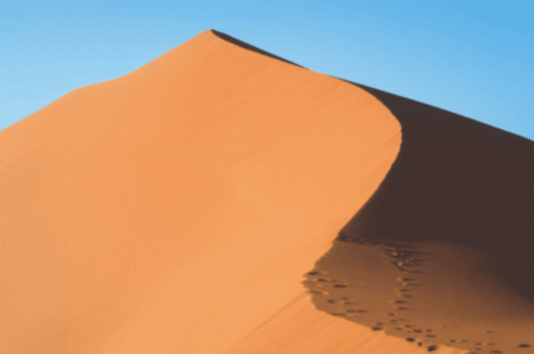 Majestic sand dune under clear blue sky in Sossusvlei Desert, Namibia
