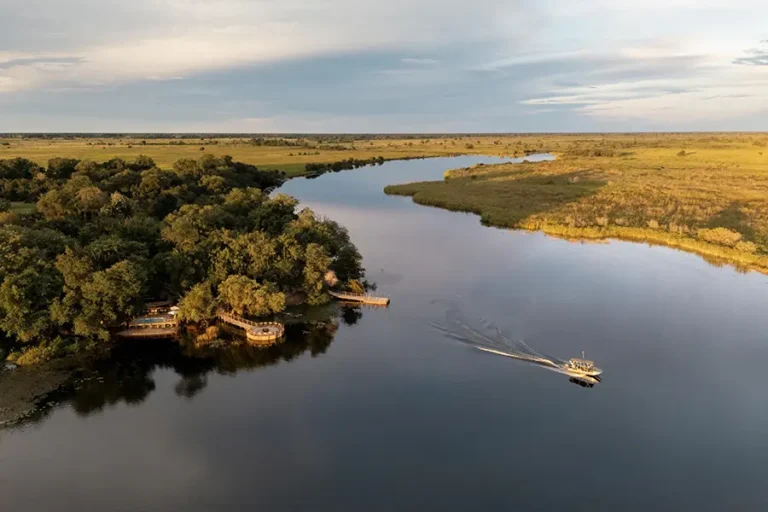 Aerial view of Xugana Island Lodge in the Okavango Delta, Botswana, showing mokoro excursions and motorboat safaris along surrounding waterways.