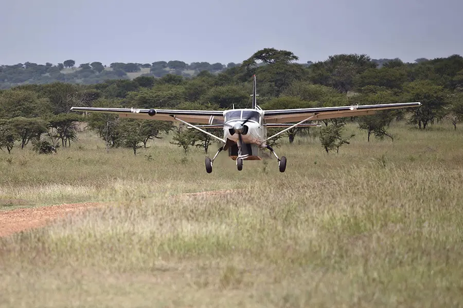 Private safari plane landing at Klein’s Camp airstrip in Serengeti Tanzania