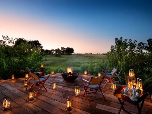 Main deck at Duba Plains Camp with firepit area for evening drinks and shared safari stories in Botswana's Okavango Delta.