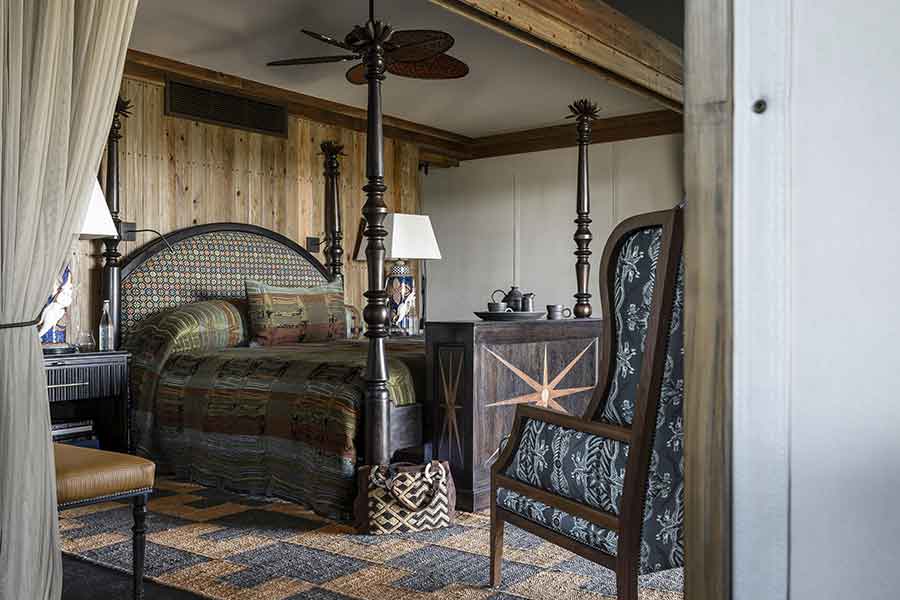 Luxury suite interior at Xigera Safari Lodge in Botswana's Okavango Delta with elegant furnishings and floodplain views.