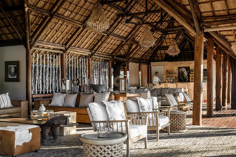 The elegant main area at Sanctuary Chief's Camp in Botswana's Okavango Delta, featuring luxury lounge spaces overlooking the floodplains.